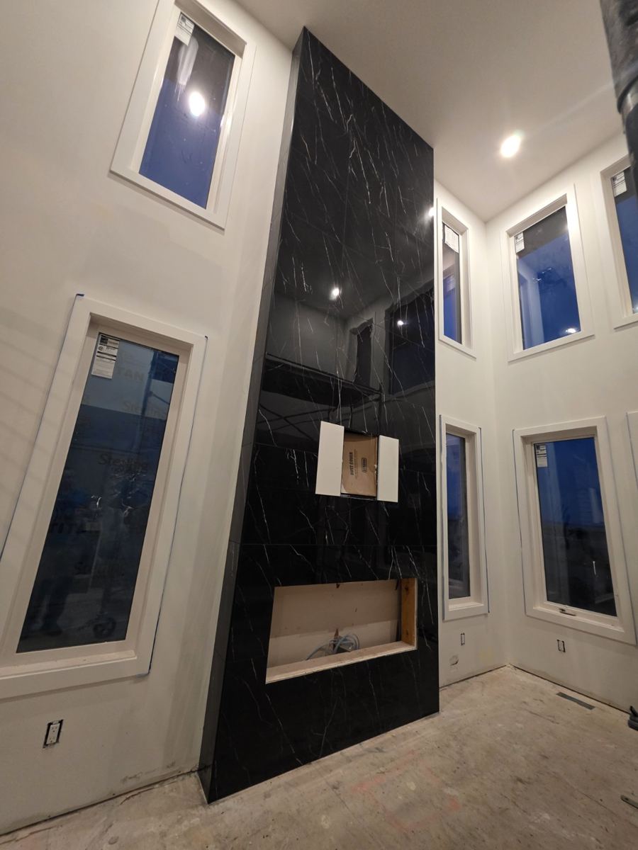 Tall tiled fireplace feature wall completed by KD Tiling